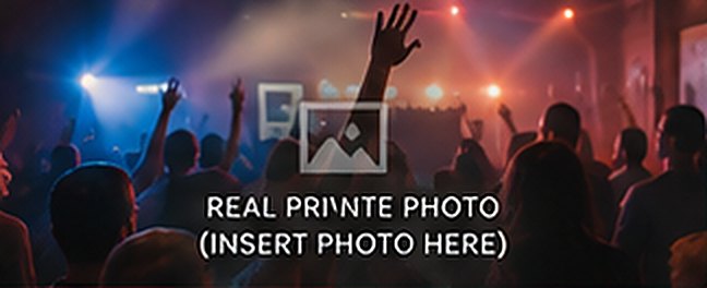 A crowd in front of a lit stage